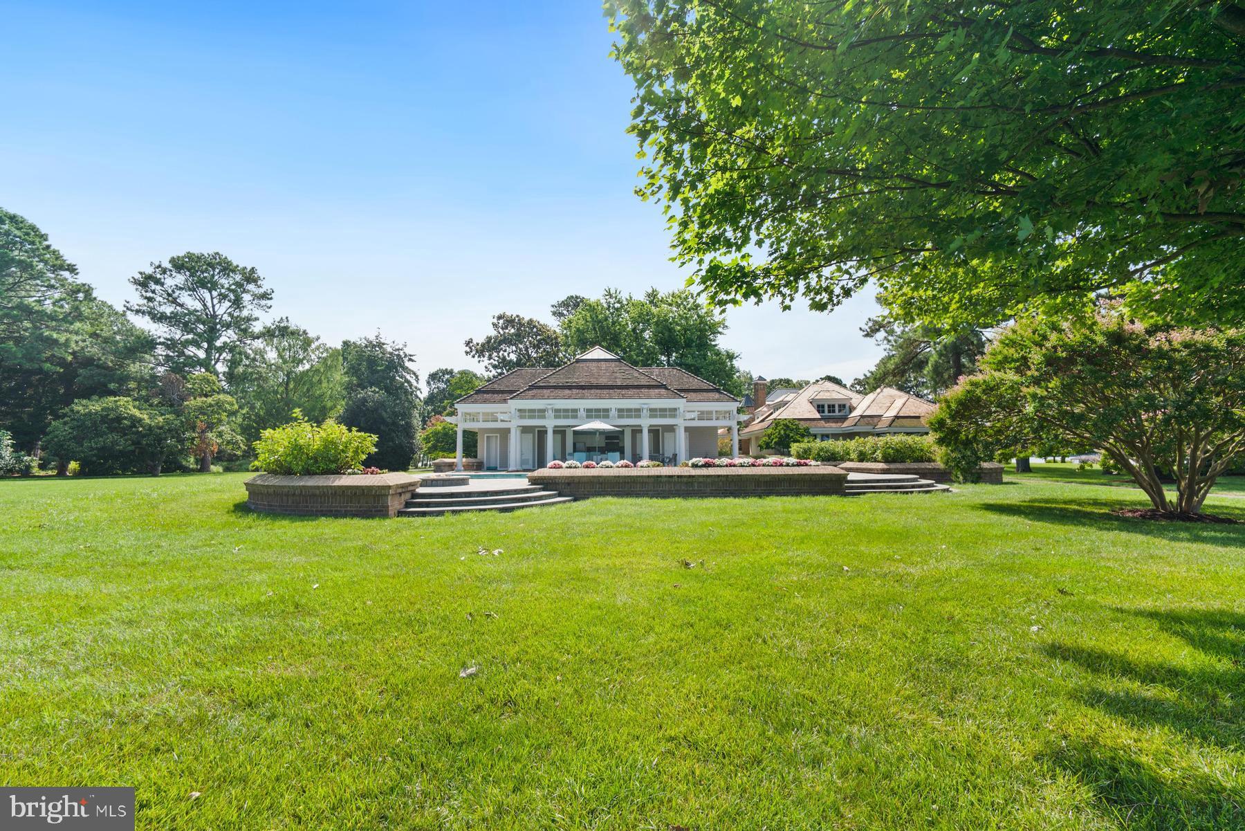 7090 Cooper Point Road Bozman, MD 21612 - Photo 68 of 86 a view of a house with a big yard and large trees