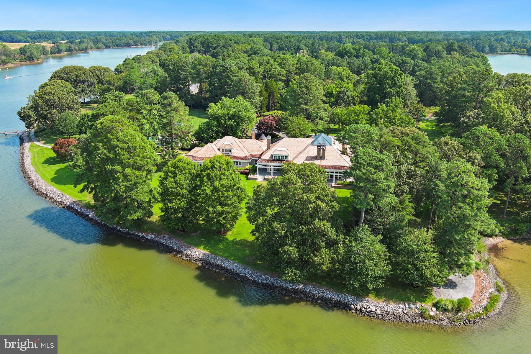 7090 Cooper Point Road Bozman, MD 21612 - Photo 7 of 86 a backyard of a house with a yard and lake view