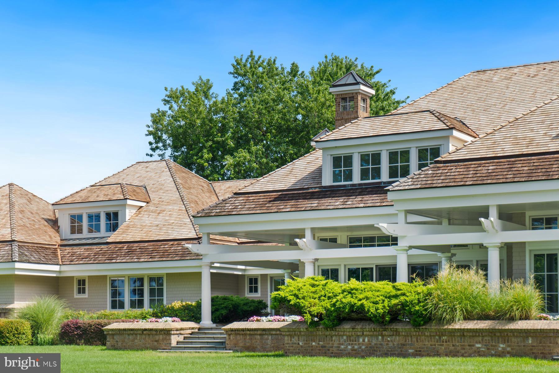 7090 Cooper Point Road Bozman, MD 21612 - Photo 73 of 86 front view of a building with a garden