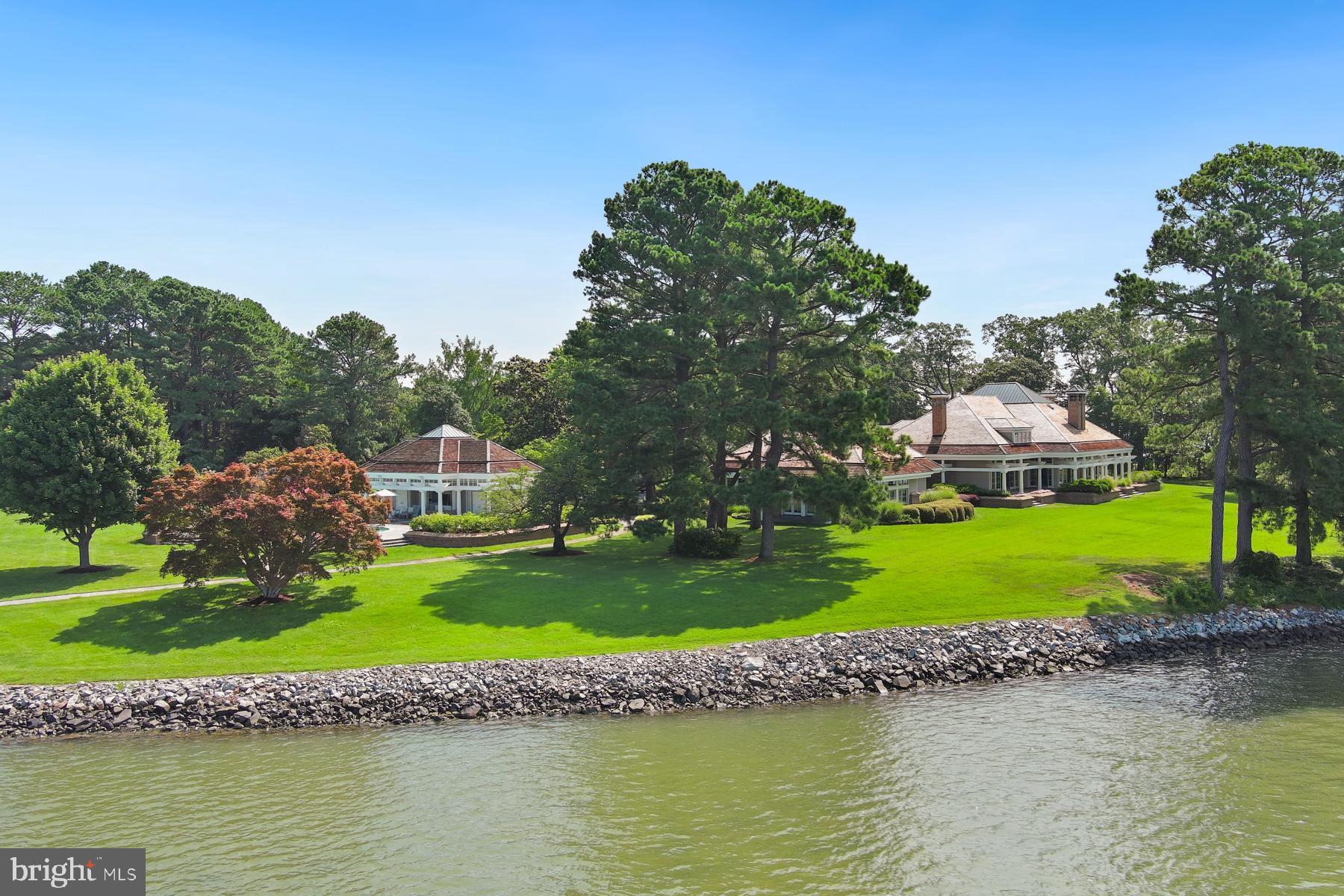 7090 Cooper Point Road Bozman, MD 21612 - Photo 80 of 86 a view of a house with a yard and a pond