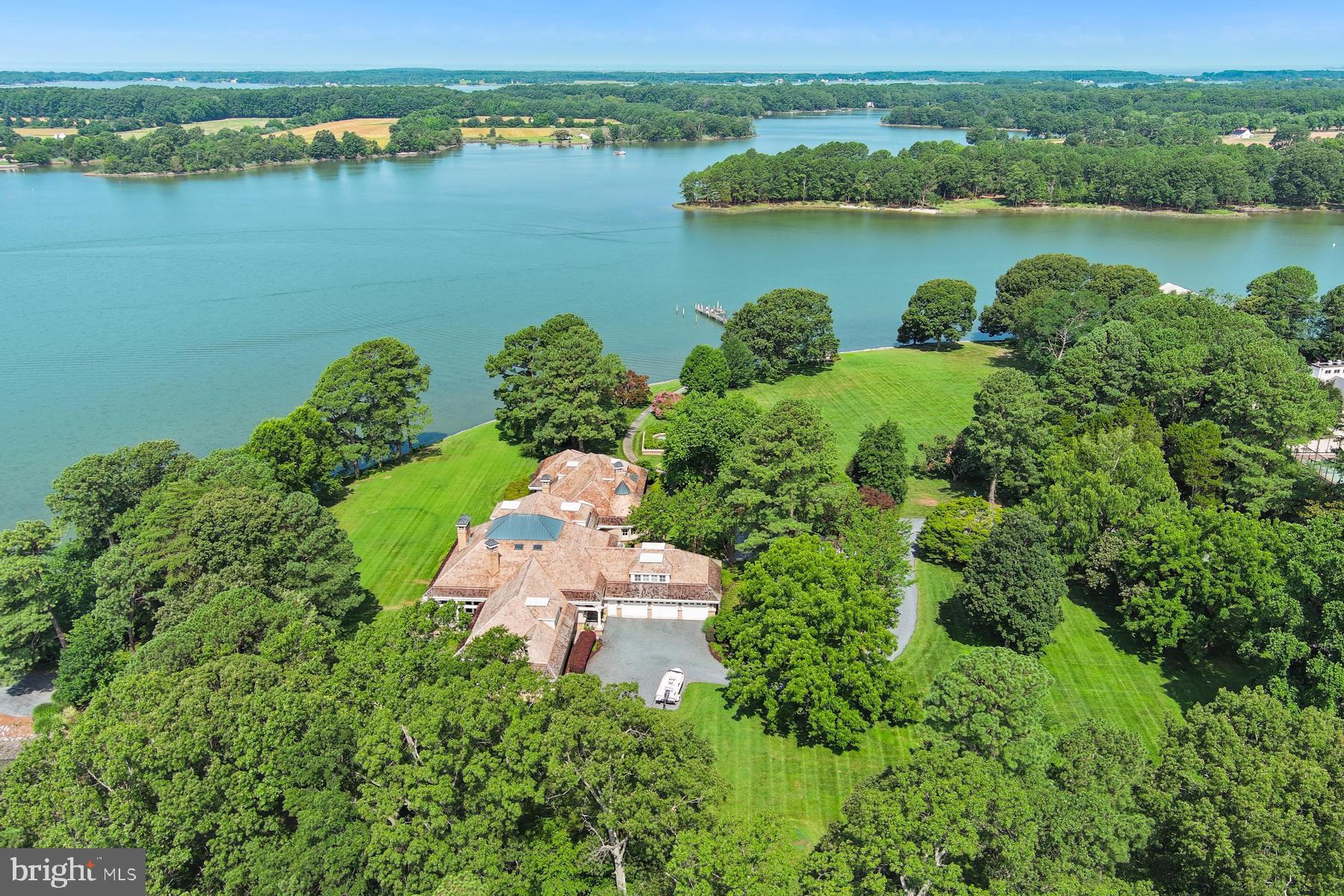 7090 Cooper Point Road Bozman, MD 21612 - Photo 82 of 86 an aerial view of a house with a lake view