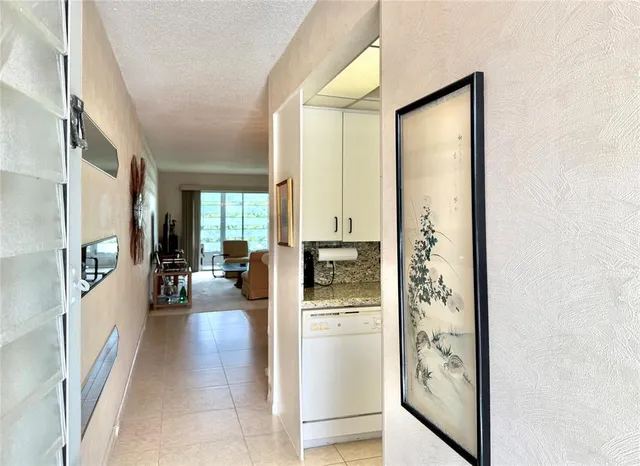 a kitchen with white cabinets and appliances