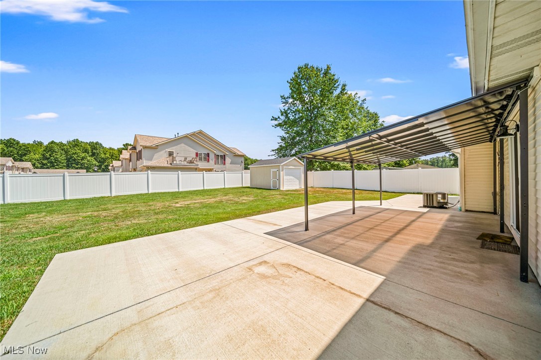 2716 Russell Road Ashtabula, OH 44004 - Photo 38 of 43 Fenced backyard featuring a patio area and a storage shed