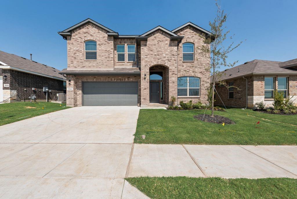 15944 Stableford Road Justin, TX 76247 - Photo 1 of 22 Two-story brick exterior featuring arched window accents and a covered entry