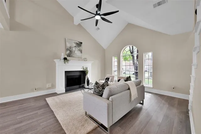 a living room with furniture fireplace and window