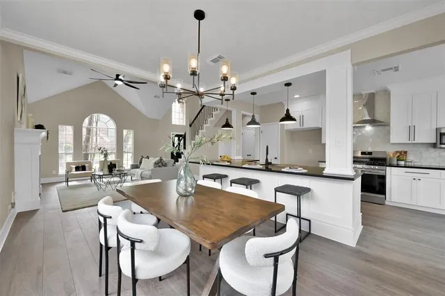 a large kitchen with a table and chairs
