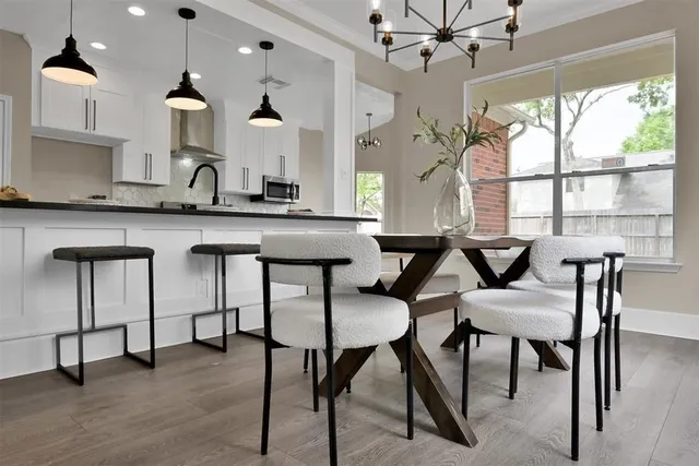 a kitchen with a table chairs stove and cabinets