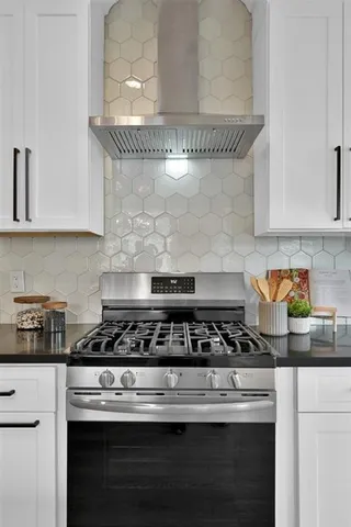 a close view of a stove a microwave and cabinets