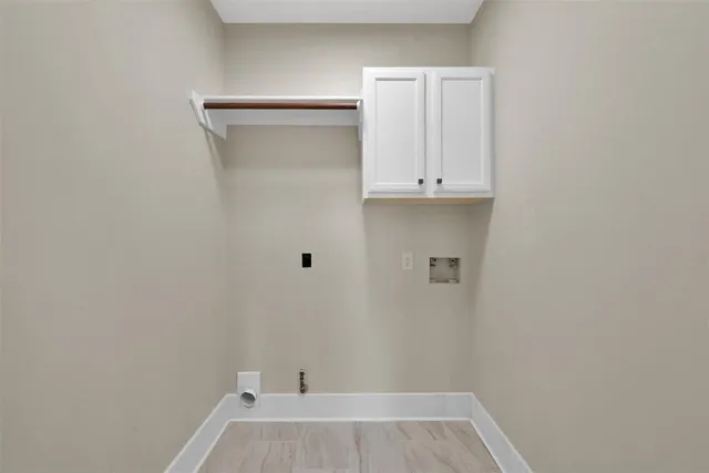 a view of storage and utility room with wooden floor