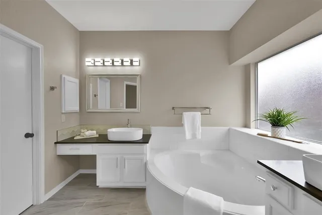 a bathroom with a double vanity sink and a mirror