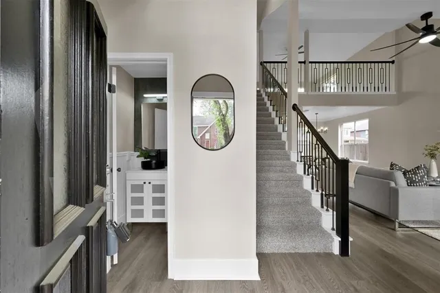 a view of a livingroom with furniture entryway wooden floor and front door