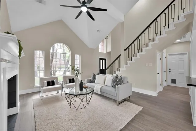 a living room with fireplace furniture and a large window