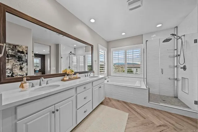 a spacious bathroom with double sink and shower