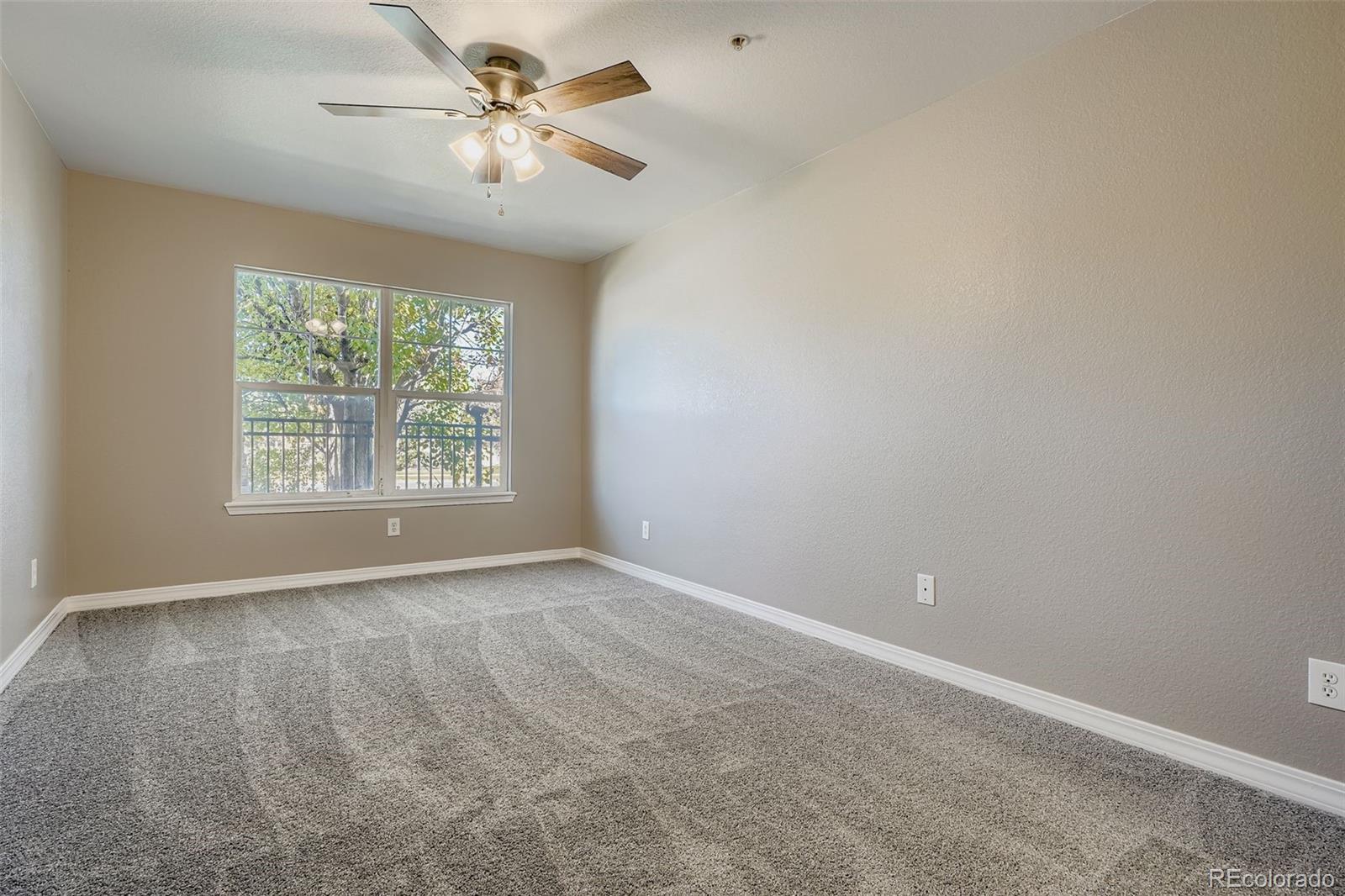 5722 South Addison Way, Unit C Aurora, CO 80016 - Photo 11 of 28 an empty room with windows and fan