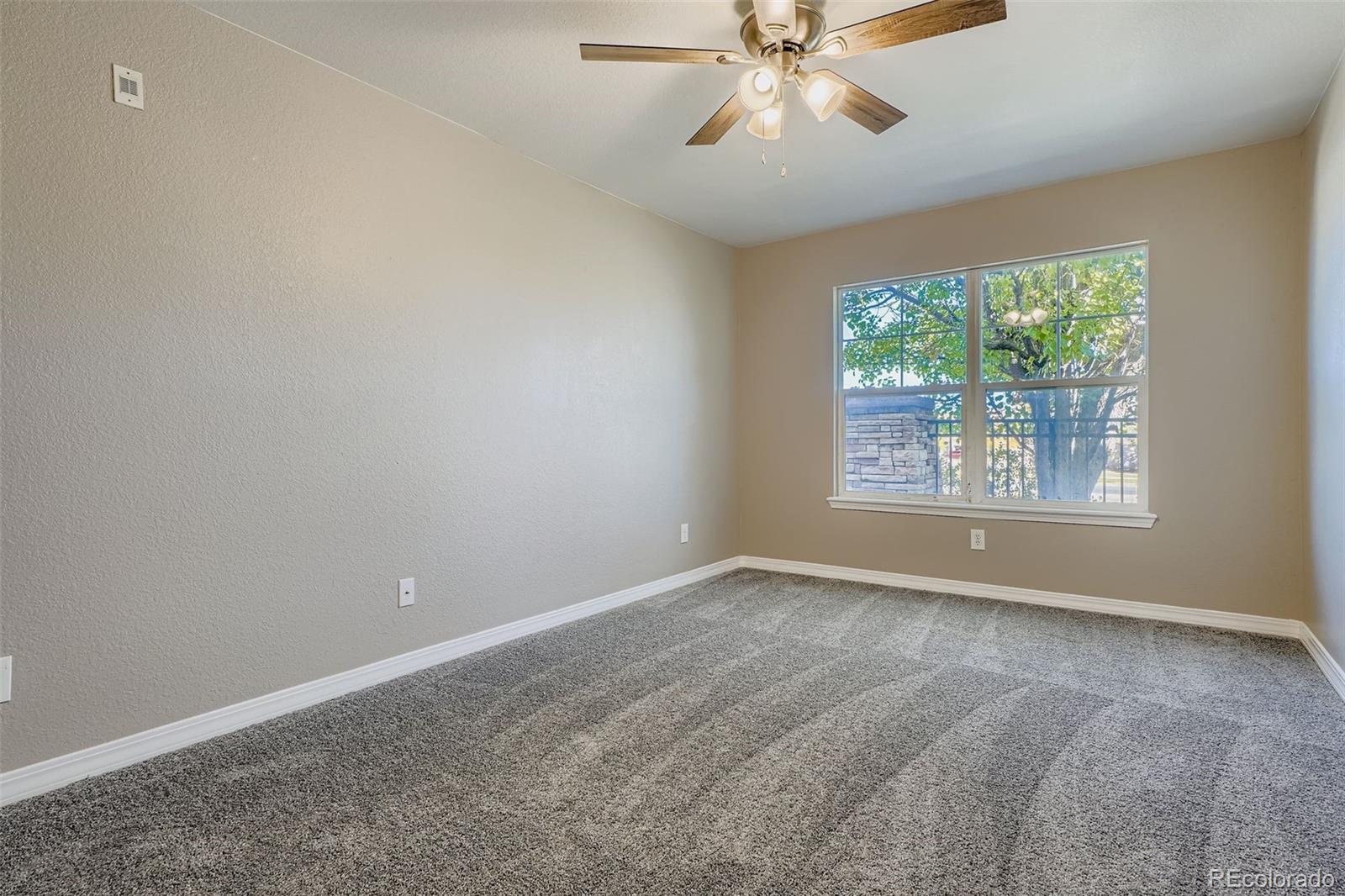 5722 South Addison Way, Unit C Aurora, CO 80016 - Photo 14 of 28 an empty room with windows and fan