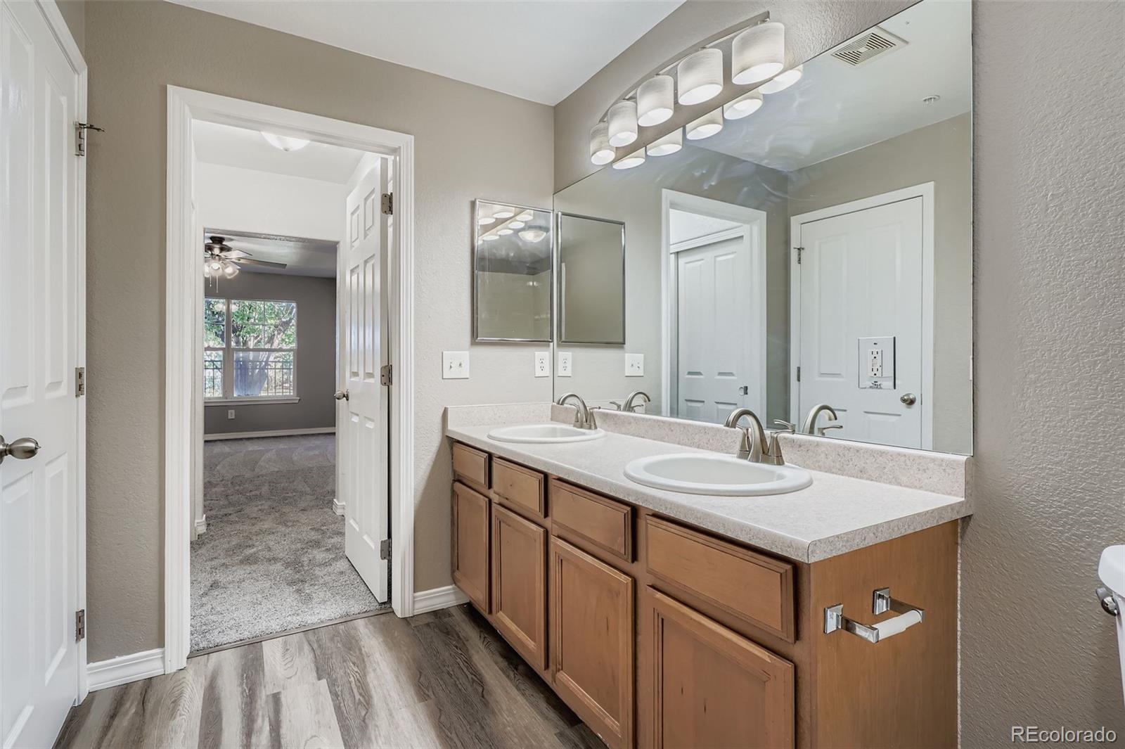5722 South Addison Way, Unit C Aurora, CO 80016 - Photo 16 of 28 a bathroom with a sink double vanity and a mirror