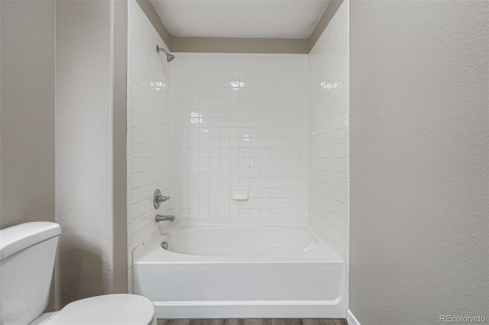 5722 South Addison Way, Unit C Aurora, CO 80016 - Photo 17 of 28 a bathroom with a toilet and a bathtub