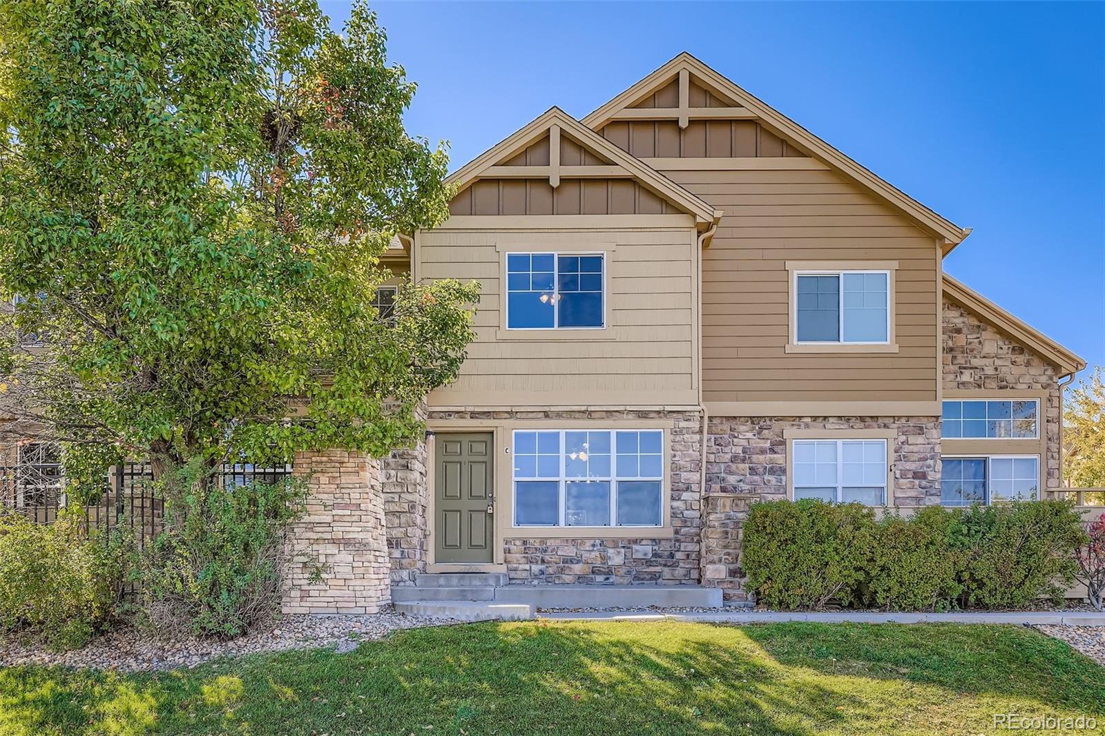 5722 South Addison Way, Unit C Aurora, CO 80016 - Photo 2 of 28 a front view of a house with a yard