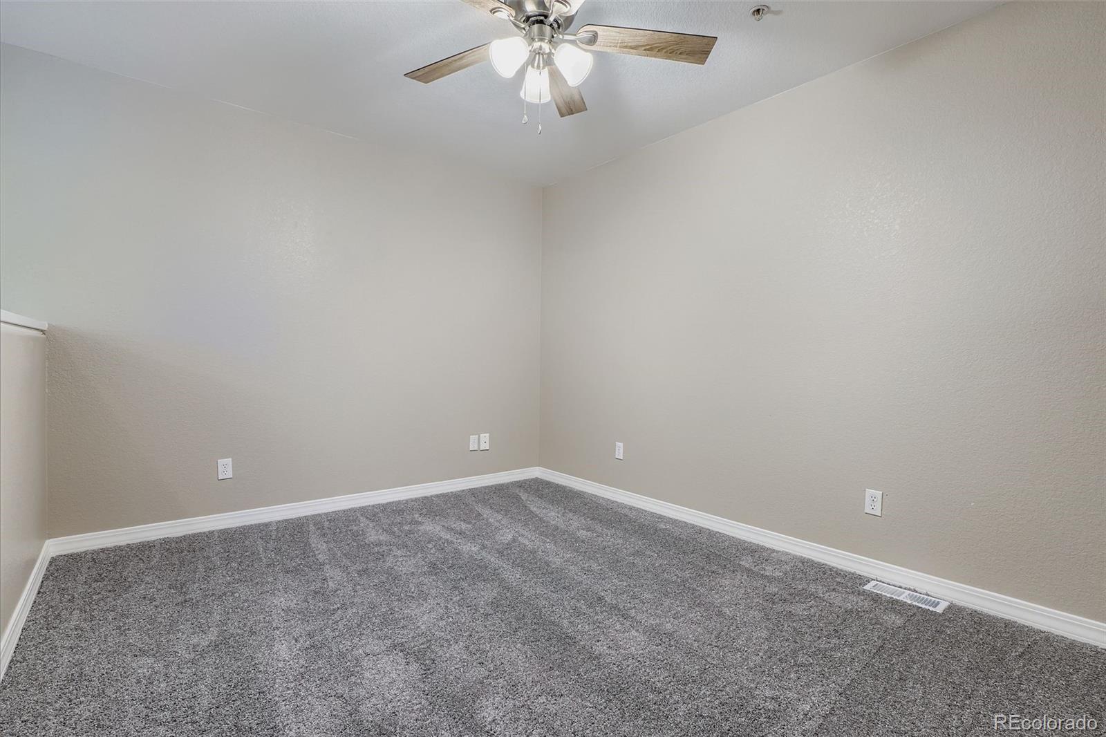 5722 South Addison Way, Unit C Aurora, CO 80016 - Photo 23 of 28 a view of an empty room with chandelier fan