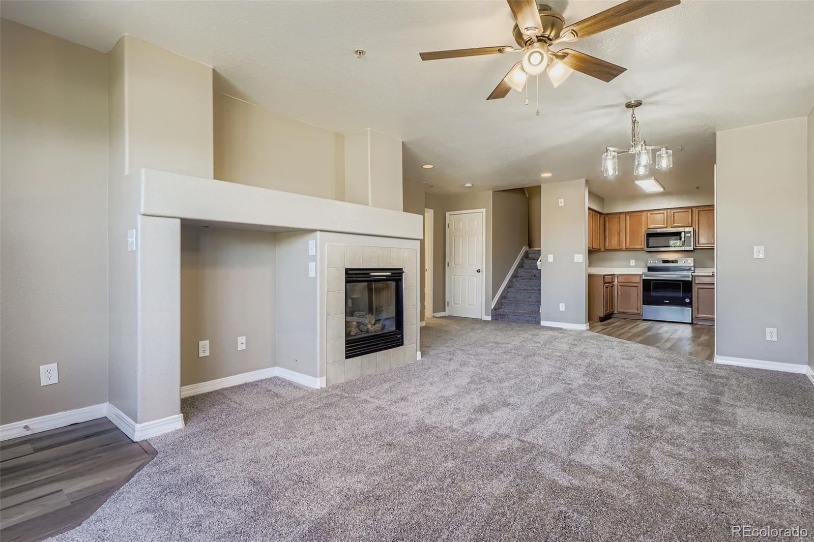 5722 South Addison Way, Unit C Aurora, CO 80016 - Photo 5 of 28 a view of a kitchen and a chandelier fire place