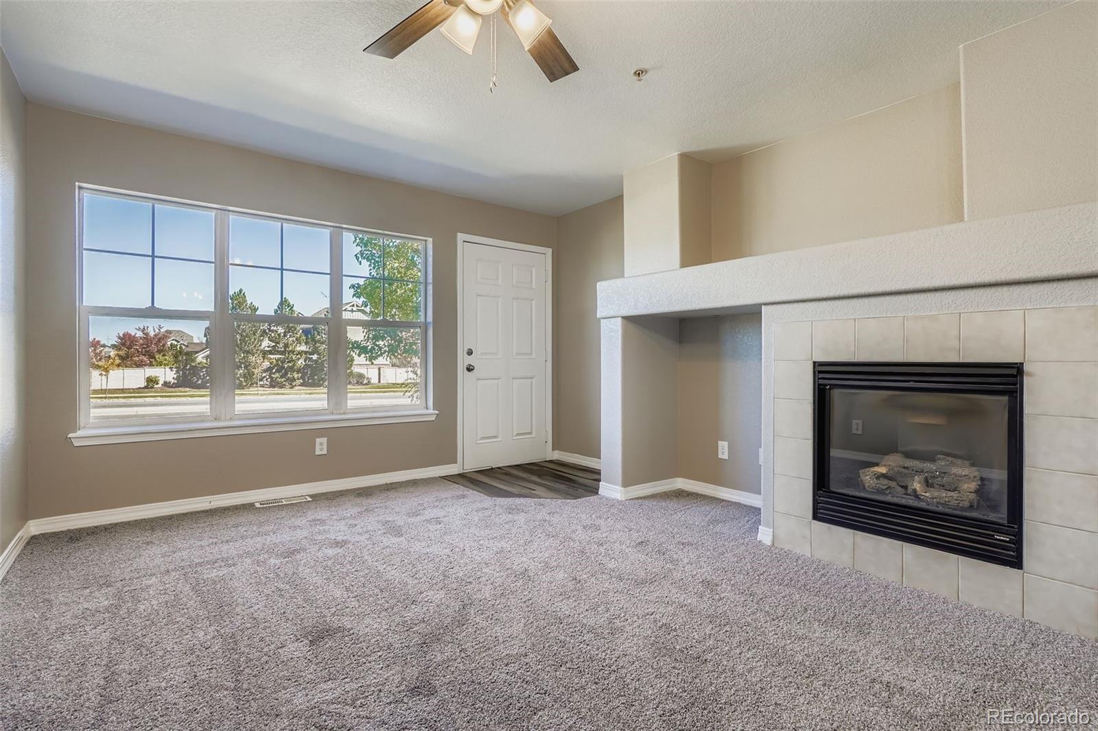5722 South Addison Way, Unit C Aurora, CO 80016 - Photo 6 of 28 an empty room with windows and fireplace