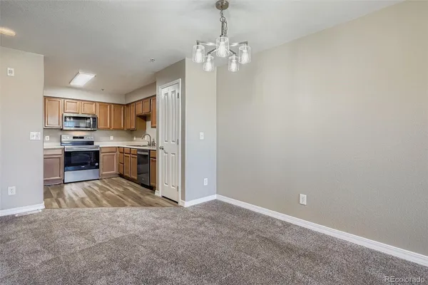 a kitchen with kitchen island stainless steel appliances a sink stove and refrigerator