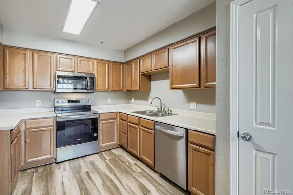 a kitchen with stainless steel appliances granite countertop a stove sink and cabinets