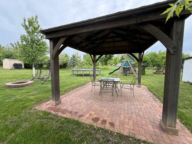 a view of backyard with green space and porch