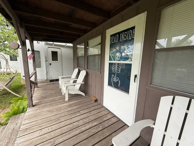 a view of a deck with chairs and wooden floor
