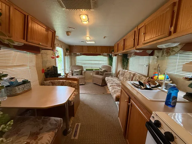 a kitchen with sink a stove and chairs