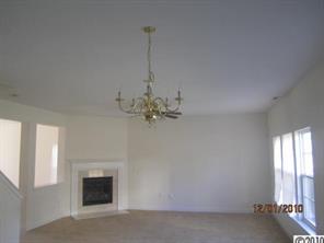 13751 Rutherglen Court Charlotte, NC 28213 - Photo 2 of 5 a view of a livingroom with a chandelier fan and windows