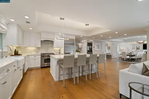 a kitchen with appliances a sink a counter top space and cabinets