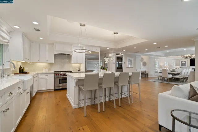 a kitchen with appliances a sink a counter top space and cabinets