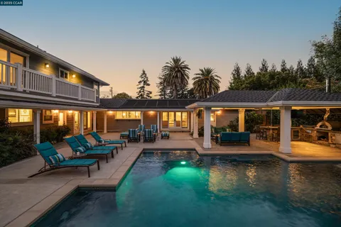 an outdoor sitting area with furniture and garden