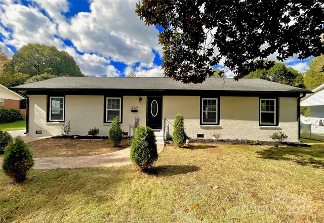 a front view of a house with a yard outdoor seating and garage