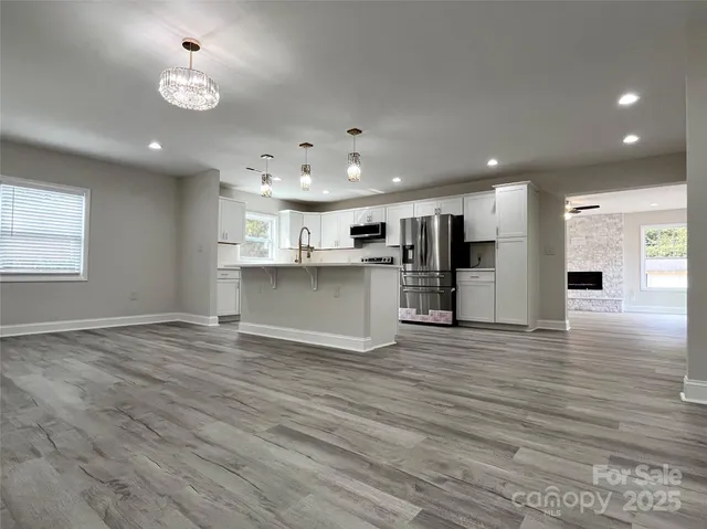 a kitchen with a sink a microwave a refrigerator and cabinets