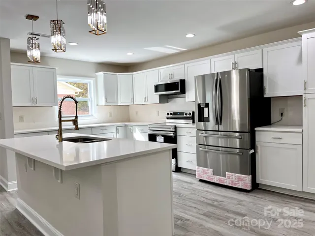 a kitchen with a refrigerator and a stove