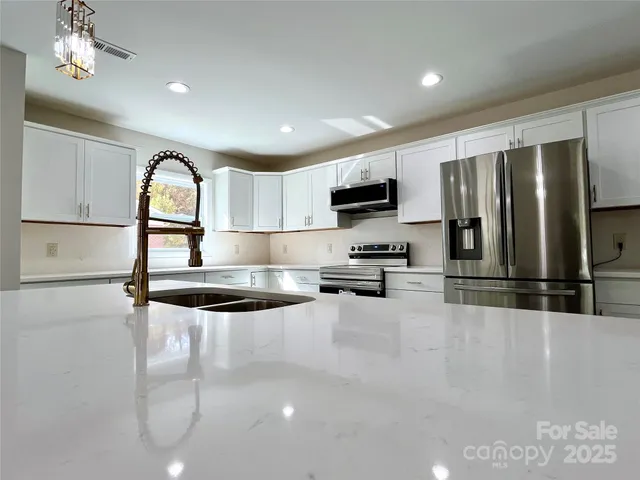 a view of an empty room with a fireplace and a window