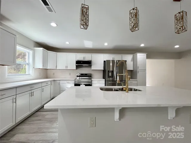 a view of an empty room with a fireplace and a window