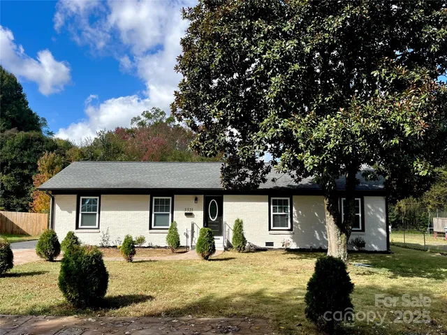 a view of a house with backyard porch and sitting area