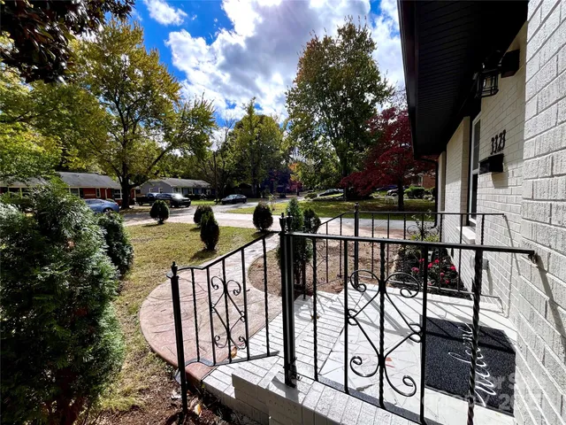 a view of empty room with window and wooden floor