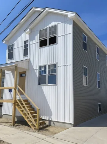 a front view of a house with wooden stairs