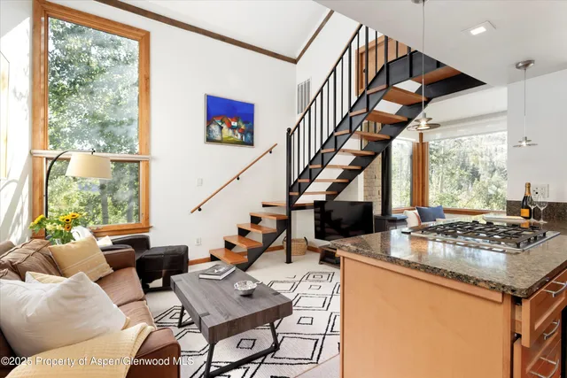 a living room with furniture and large windows