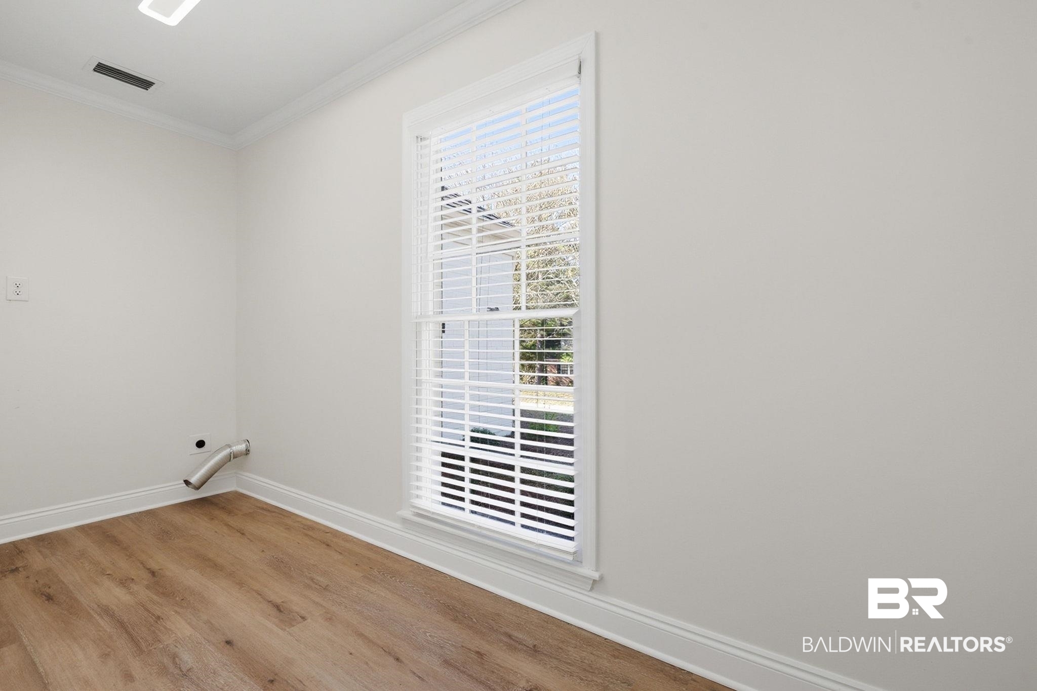 814 Nassau Drive Mobile, AL 36608 - Photo 12 of 44 Unfurnished room with crown molding and light wood-type flooring