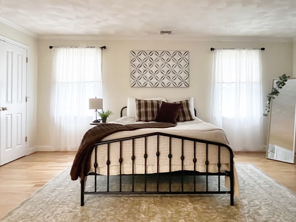 216 Rangeway Road, Unit 153 Billerica, MA 01862 - Photo 14 of 31 a bedroom with a bed and wooden floor