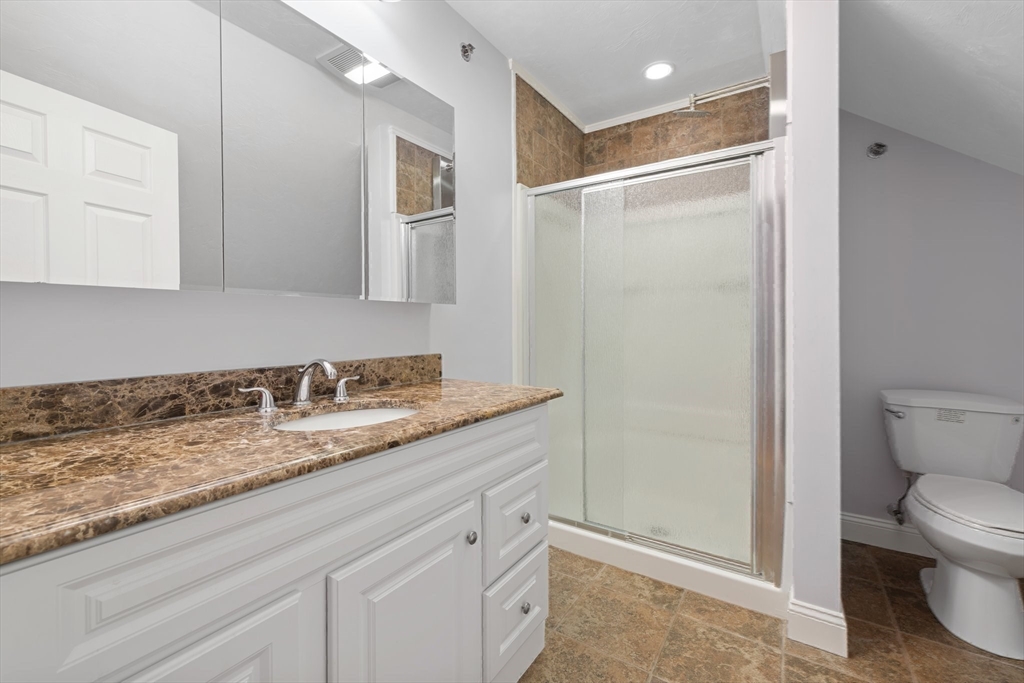 216 Rangeway Road, Unit 153 Billerica, MA 01862 - Photo 29 of 31 a bathroom with a granite countertop sink toilet and shower