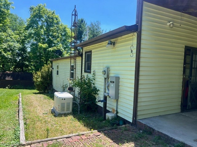 2860 Run-A-Round Road Junction City, OH 43748 - Photo 14 of 22 View of property exterior with a yard and central AC
