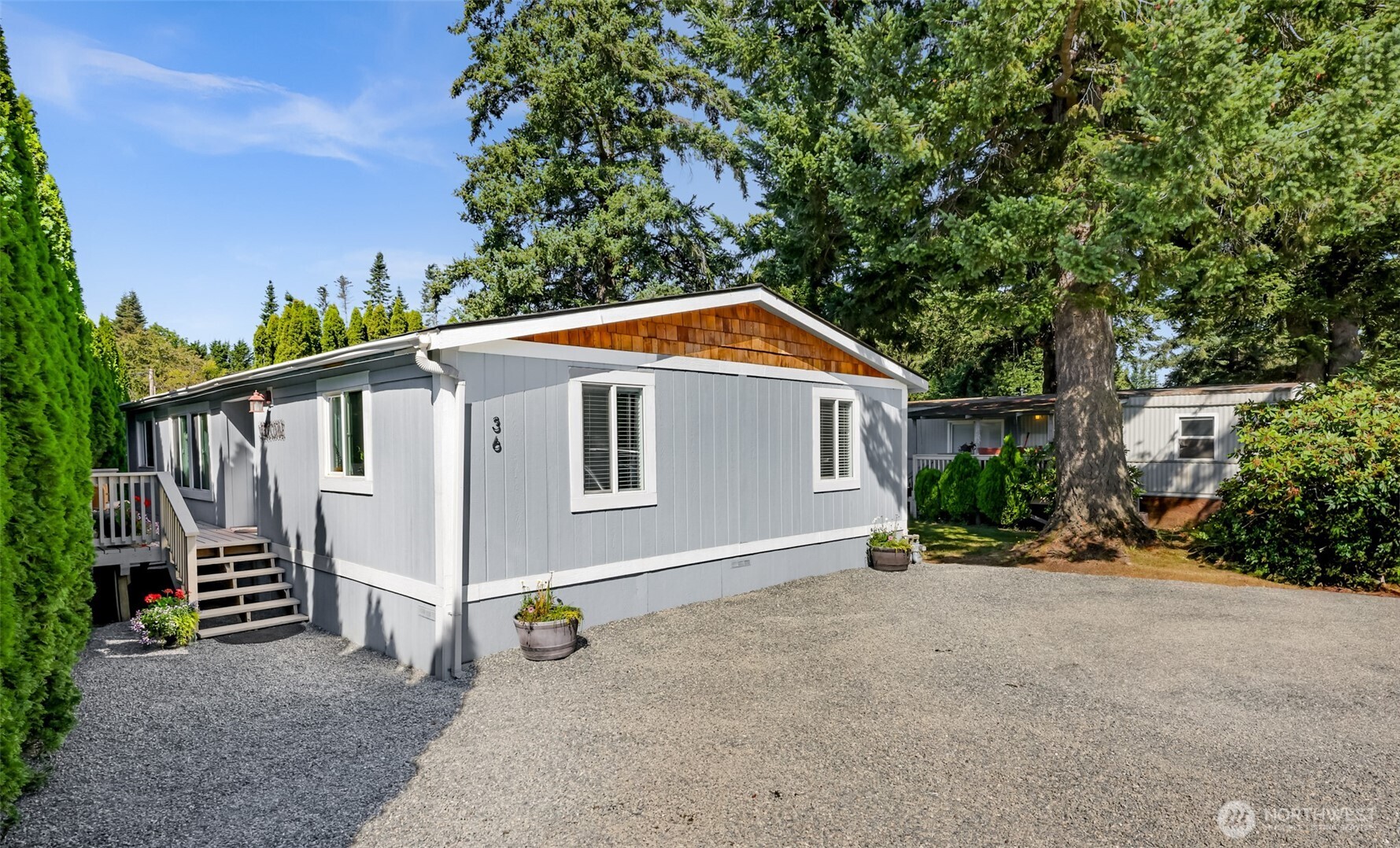 a view of a house with backyard and sitting area