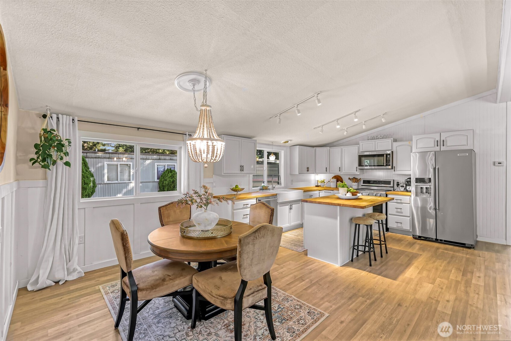 1014 West Smith Road, Unit 36 Bellingham, WA 98226 - Photo 27 of 32 a dining room with stainless steel appliances a dining table and chairs