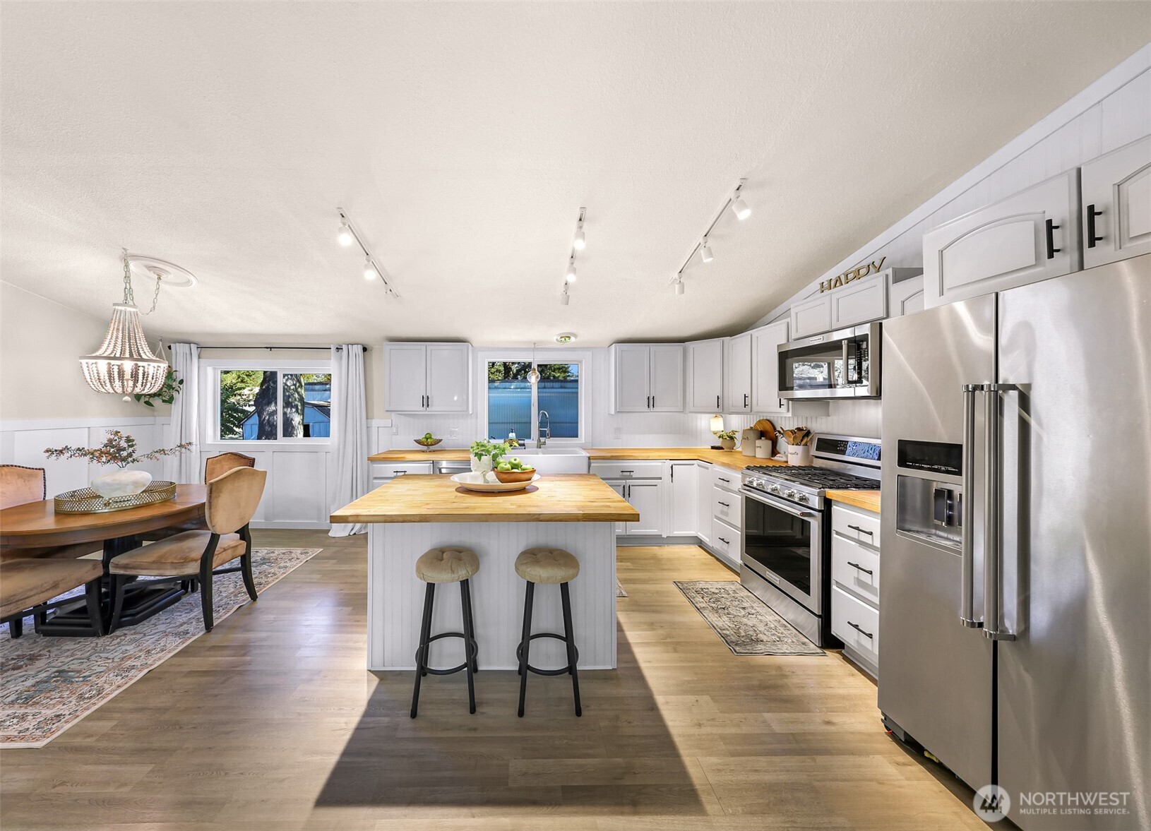 1014 West Smith Road, Unit 36 Bellingham, WA 98226 - Photo 8 of 32 a open kitchen with stainless steel appliances granite countertop a stove refrigerator and dining table with wooden floor